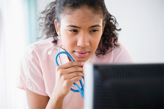 Female nurse looking at computer screen